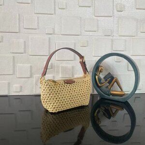The Hills Pochette clutch is elegantly constructed in raffia